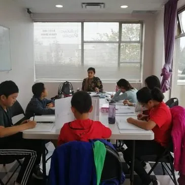 Students working together around a table in a Fresh Minds Academy classroom